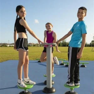 Children using an ExoKids youth fitness station (Ages 5-12) on a blue safety surface in an open park.
